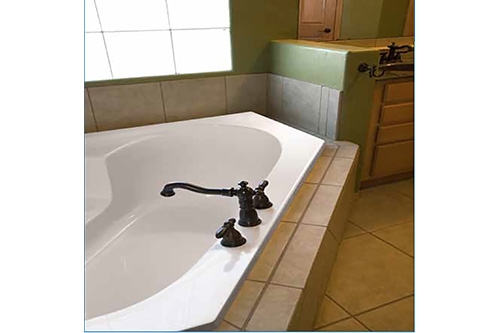 Rincon Beauty tub incased in large beige tile